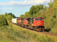 On a very cloudy day, the sun poked its way out just in time for CN 435 to make its way down the grade at MM30 on the Halton sub with CN 2652 leading CN 5715 and a dirty BCOL 4609 for power.