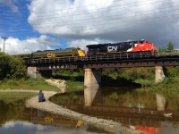 CN 3105 and CN 102 were the locomotives on the southeast end of the annual CN Family Day Train in Winnipeg, which ran between Symington Yard and the Seine River several times. Here, they are beginning their trip back towards Symington Yard as they cross the Seine River.