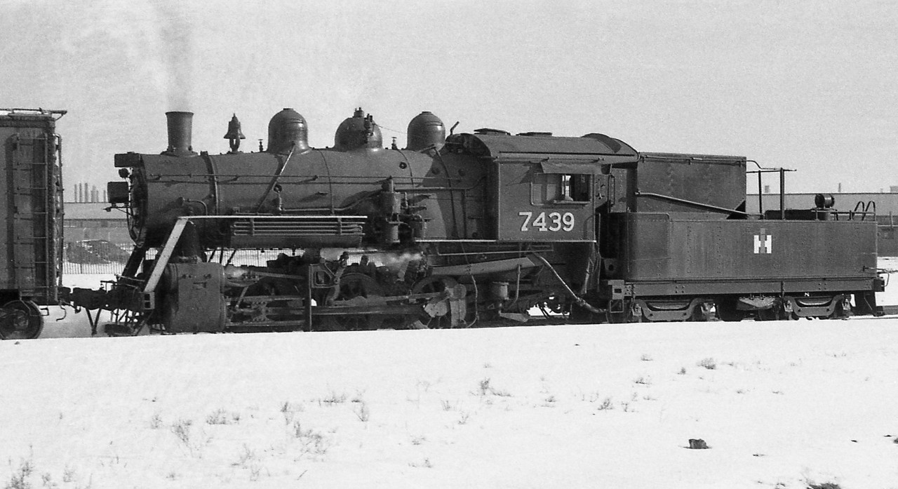 Ex-Canadian National 0-6-0 7439 (O-18-a class, nee-GTR) switches the International Harvester plant in Hamilton in 1960. Sold to IHC in 1958, it was apparently scrapped 3 years later in 1961. Only two other CNR O-18's fared better, 7456 and 7470 which were sold to Canada and Dominion Sugar (Redpath) for plant switching.International Harvester Company of Canada (later Case IH) owned a few small steam and diesel locomotives over the years to switch its Hamilton plant trackage, including ex-TH&B 0-6-0 43 that was operated prior to 7439 arriving, and ex-Erie Lackawanna Alco S1 308 acquired in 1968 (that later went to Trillium).