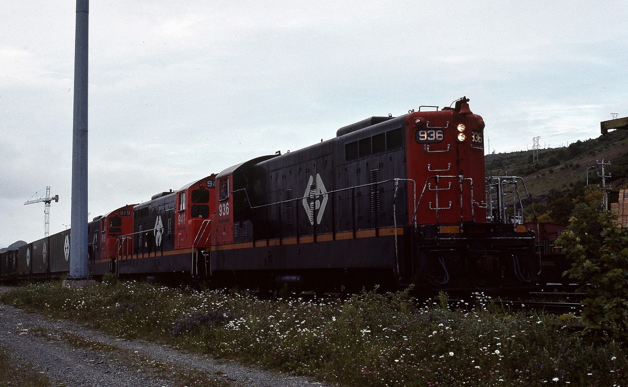 AMONG THE LAST - Terra Transport Extra 936 West with three units prepares to depart the St. John's Yard for Port aux Basques on the grey evening of July 28, 1988. Knowing that time was quickly running out for the Newfoundland operations, this was the among the very last full length revenue trains to operate westbound and the very last to be captured by the photographer. Despite the pristine condition of the NF210's, within eight weeks they would be shut down for good on the Island, with lead 936 being preserved at Avondale, 941 sold to F.C. del Pacifico of Nicaragua and 919 being scrapped.