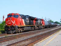 CN-3036 a EF-644T leading with CN-2975 a EF-644R pulling tanks cars and other freight cars  on rte.377 