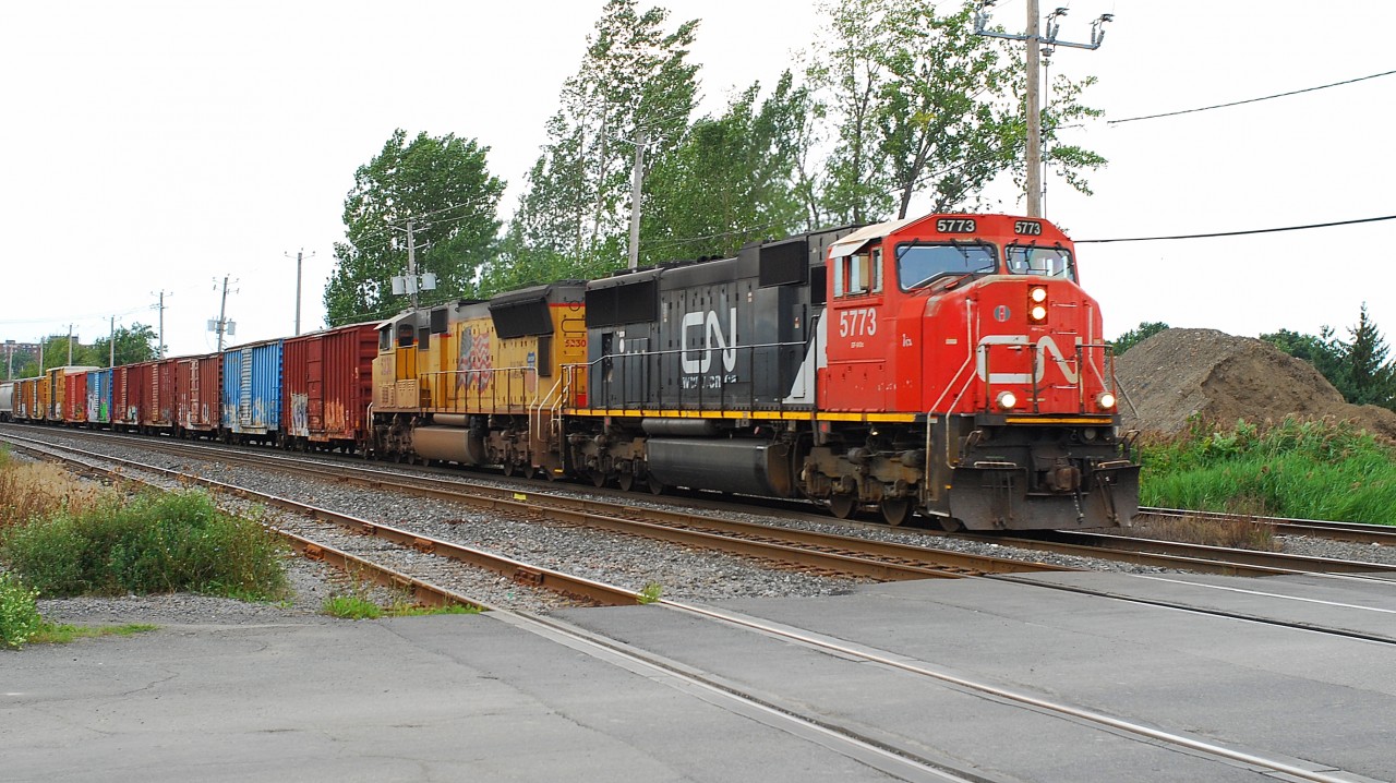 CN- 5773 GF-643-c with Union Pacific 5230 SD-70-M2  coming from Taschereau Yard  route 394