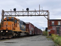 213 passing by the abandoned Swastika station with SD40-2 #1735 in charge of 55 cars
