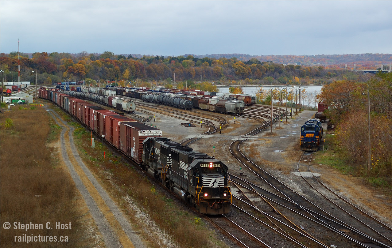 Back to my oldies yeah, not that long ago.. but a pair of EMD SD60's lead Norfolk Southern's St. Thomas, Ontario to Buffalo, NY train 328 at Hamilton, long before the thought of a new GO station that completely obliterated the scene you see here. This was six months after getting my Digital SLR and I was well on my way to learn how to compose a passable image. Trust me, there were mistakes, but little gems like this make it all worthwhile. While only two years remained for NS trains into Ontario - NS H3R (Buffalo NY to Fort Erie, ON) continues to this very day with the same St. Thomas based (Wabash) crews. Youngins are advised to head to Fort Erie to get it while you can - your time machine awaits!