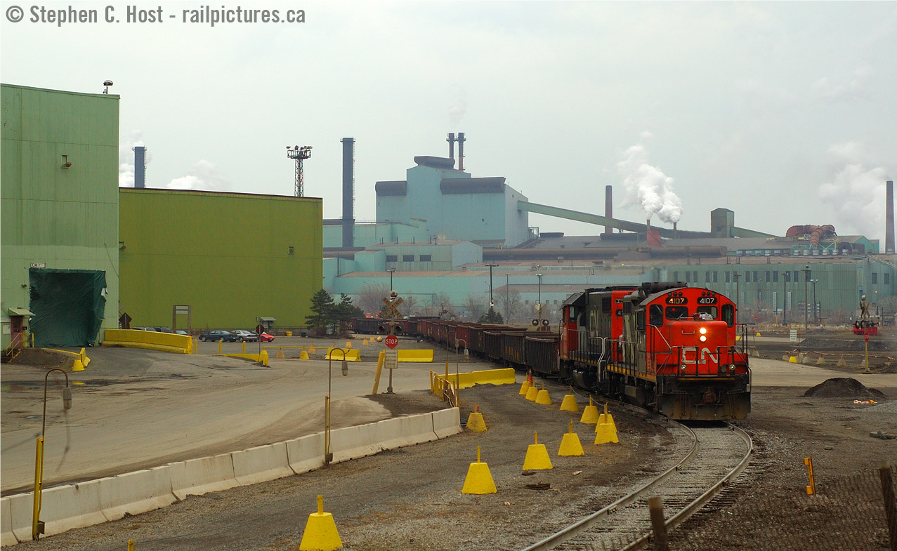 Here's another shot for Dave Young - this isn't the Steel Train, nor is it CN - it's a SOR local lifting raw steel billets in Gondolas using whatever CN power was assigned to 'em. (The steel train 599/598 ran late late afternoon west / early morning loaded east often in darkness). Stelco deserved about a switch a day from each railway (SOR and CP) in this time-frame after the Chinese economy went all hot and steel was in HOT demand. Stelco went into receivership in 2007, but was awash in money due to high steel prices, and we still hadn't hit peak steel demand. US Steel emerged to buy Stelco not long after this and continued to pump out steel until the blast furnaces were idled in 2012. The bloom was off the rose - Chinese steel companies were (and continue to) dumping cheap steel on the market and steel prices have been in the tanks ever since (there has been some recovery in 2016 though). BlackRock Investments (A New York  Hedge fund) has emerged as the winner to take over the former Stelco - away from US Steel and while I shudder at the thought of another hedge fund meddling (Since it'll just be another kick at the union and their Pensioners) if the economy does recover it's highly possible Stelco may once again rise from the ashes.