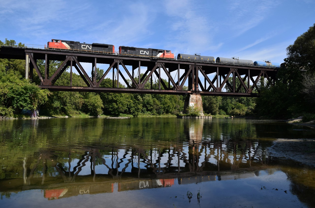 A pair of EMDs are in charge of CN 371 as it cruises over the Thames River trestle. The wind even died down a bit right before the train went by, making the reflection look a bit better.