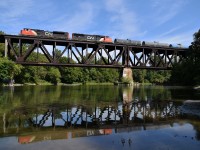 A pair of EMDs are in charge of CN 371 as it cruises over the Thames River trestle. The wind even died down a bit right before the train went by, making the reflection look a bit better. 