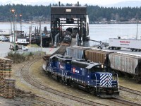 During the early morning hours SRY 119 and companion SRY 110, in attractive Rail Link livery, are systematically unloading deliveries and then loading empty rail cars on the MV Carrier Princess at Seaspan's Coastal Intermodal Ferry Terminal at the Port of Nanaimo on Vancouver Island, BC.  The mainland connecting port being Seaspan's Tilbury Terminal, Delta, BC.  Note the use of customary buffer cars, etc.  This certainly was a most interesting, viable and impressive rail - marine service at the time of my brief visit to the Vancouver Island March 2009.