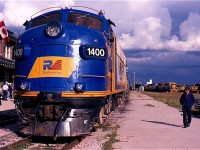 The year 2003 was a busy one for Essex Terminal steam engine #9. The old engine spent a fair amount of time stretching its legs across Southern Ontario. In October it spent the better part of a week operating over the various lines operated by the Goderich -Exeter RR. It's companion for these trips was recently transferred Railink FP9 #1400. This day the fan trips operated between Stratford and St. Mary's. The train has just returned from St Mary's and is unloading its passengers when the sun briefly breaks through the mainly cloudy skies. In the background GEXR road train 431 has just arrived from Toronto with a rainbow consist of four axle Geeps. This would turn out to be the high point for FP9 #1400 during its life on the GEXR with its remaining years spent hauling loaded salt and grain trains out of Goderich until it and sister 1401 were retired and gradually stripped of usable parts to keep GEXR's lone surviving GP9 in service. The Ontario Southland would eventually rescue both 1400 & 1401 from a scrapper and today both are out on the road serving the OSR.