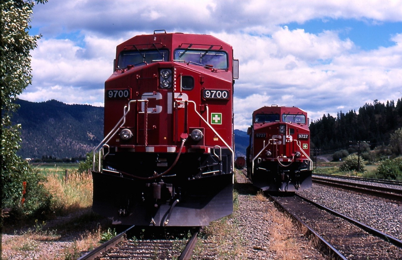 By the summer of 2003 EMD power was getting rare on CP west of Calgary. The 9700 series of GE built AC4400s were some of the newest motive power on the roster. At Chase a pair of 9700s await their next assignment on a siding while a grain train can be seen sitting in the distance. It was unclear to me this day if these two AC4400s were to be used as head end power or DPU on their next train.
