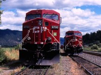 By the summer of 2003 EMD power was getting rare on CP west of Calgary. The 9700 series of GE built AC4400s were some of the newest motive power on the roster. At Chase a pair of 9700s await their next assignment on a siding while a grain train can be seen sitting in the distance. It was unclear to me this day if these two AC4400s were to be used as head end power or DPU on their next train.