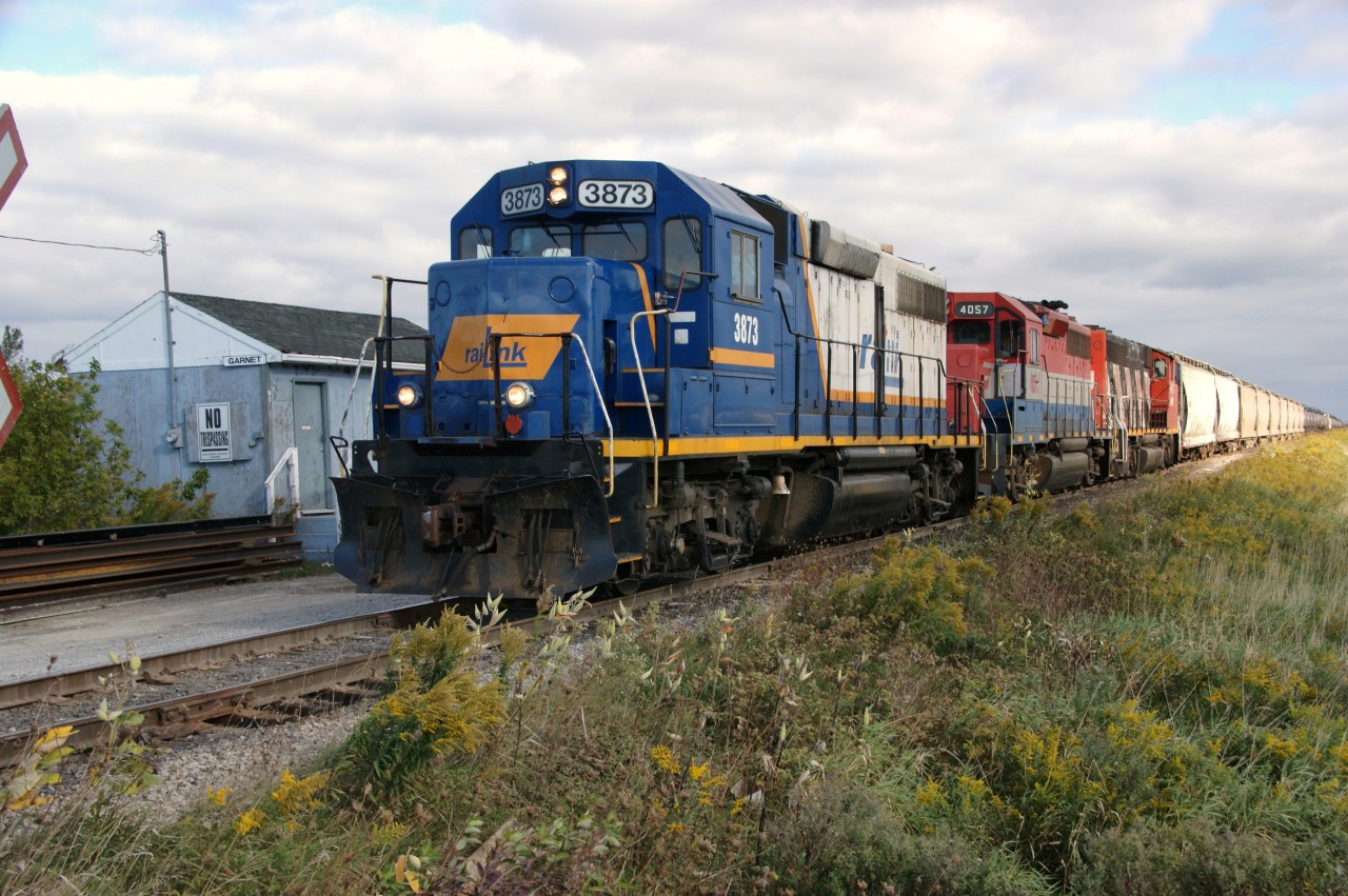Here is another photo featuring the much traveled locomotive with a coat of many colours.  RLK 3873, in Rail Link livery, with stablemates RLK 4057 and CN 9431 are coasting home to Garnet with SOR 595 in early morning light.  When looking at this photo taken a mere 6 years, one is quickly reminded just how much livery colours and landscapes have changed. This submission is intended to compliment recent photos and info supplied by James Gardiner and Joe Bishop (RLHH 2081 in Genesee & Wyoming colours) and Rob Smith (TOR 2000 in New Hampshire & Vermont livery).  Welcome back 'Queen' and hopefully to trot on the Hagersville Subdivision and my favourite turf Garnet!