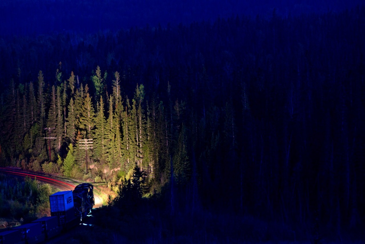 CN 119's headlights overpower the final vestiges of natural light as it wait's at a stop signal at the east end of Swan Landing.