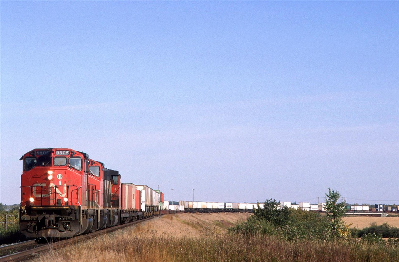 This westbound intermodal train is arriving in Edmonton. If it has to business in Edmonton, it will run through town to Bissel yard, where it will be re-crewed before continuing west.
This was a typical consist for an intermodal train at the time - mixed TOFC, COFC and double stack. To be sure, there were also pure double stack trains, also.