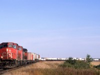 This westbound intermodal train is arriving in Edmonton. If it has to business in Edmonton, it will run through town to Bissel yard, where it will be re-crewed before continuing west.This was a typical consist for an intermodal train at the time - mixed TOFC, COFC and double stack. To be sure, there were also pure double stack trains, also.