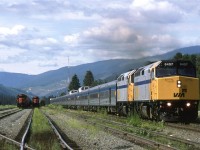 VIA made a quick stop in Blue River and then accelerated out of town. Two CN eastbound trains wait in the yard for crews or the signal to leave.
