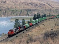 An eastbound double stack train swings through the big curve in Juniper Beach Provincial Park. The campground is in that grove of trees just above the rail cars. It is not a place for peace and quiet. Cn has a level crossing that they have to signal for and CP runs on the hill above the park across the North Thompson River. Otherwise, it is a nice little park, that seems to be expanding its boundaries over the years.