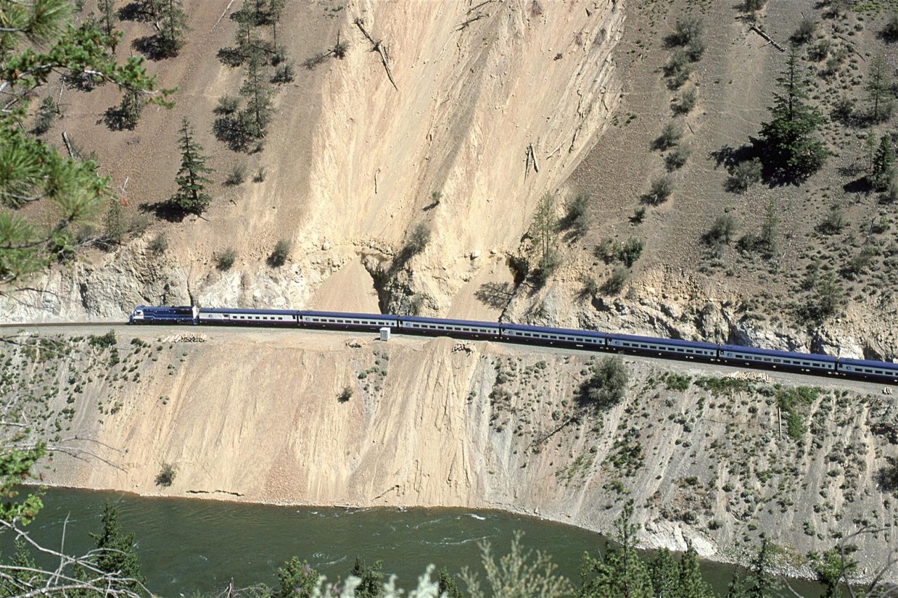 The westbound "Rocky Mountaineer" tiptoes over a piece of track that had seen a recent landslide while traversing the spectacular White Canyon. The scar below track level may have been made by the original slide or, perhaps, CN has permission to dump there and into the river.