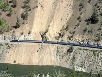 The westbound "Rocky Mountaineer" tiptoes over a piece of track that had seen a recent landslide while traversing the spectacular White Canyon. The scar below track level may have been made by the original slide or, perhaps, CN has permission to dump there and into the river.