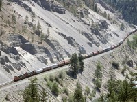 A westbound grain train is in the eastern end of White Canyon, where loosely consolidated sediments form the walls (likely the result of glacial damming in the downstream Lytton area and subsequent flooding of this valley. This, of course, and the fact that the white rock in the area is easily weathered).  