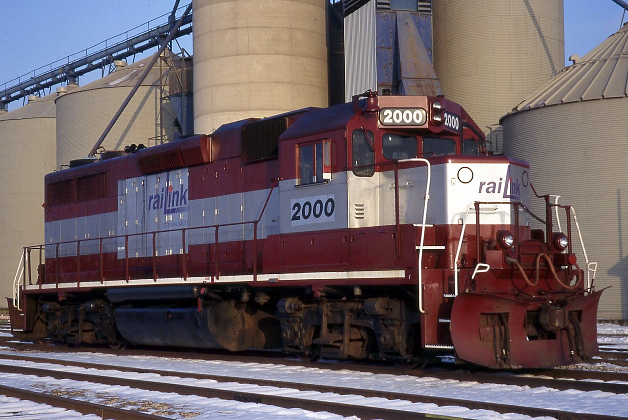 Originally built as Maine Central 258, Ottawa Valley Railway 2000 is shown sitting in Hagersville two months after start up of Southern Ontario Railway's operation on the Hagersville Subdivision.  The unit wears the colours of the failed New Hampshire & Vermont.  I don't know how long TOR 2000 was in Ontario, I believe it was brief, as it was likely shipped off to Alberta for the start-up of the Mackenzie Northern Railway in 1998.  It was there that the unit became RLK 3873.  The GP38 ultimately found its way back to the Southern Ontario Railway, operating as RLK 3873 for many years.  It outlived Rail America, retaining the RaiLink blue/white scheme and then was neatly patched when Genesee & Wyoming purchased Rail America.  G&W shipped out RLK 3873 for rebuild, and the unit returned to home rails 2016-10-27 as a GP38-2 dressed in G&W corporate orange and black, and renumbered again as RLHH 2081.  There can't be too many locomotives to work for the same railroad having three distinctly different reporting marks, number, and paint scheme!