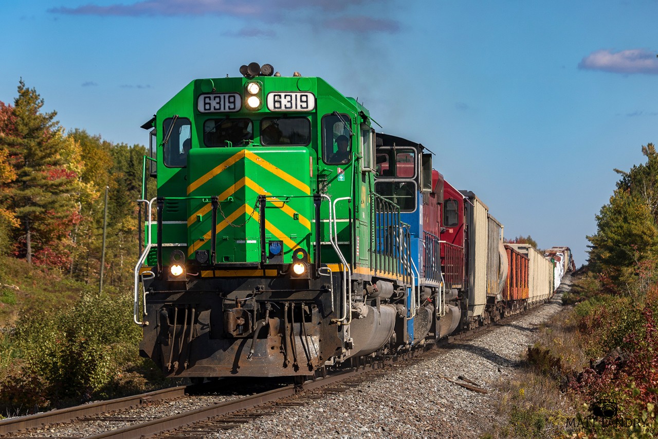 Negotiating some of the grades along the McAdam Sub, NBSR 6319 is westbound, as they approach Cork, New Brunswick, nearing the mile 59 hotbox on the McAdam Sub.