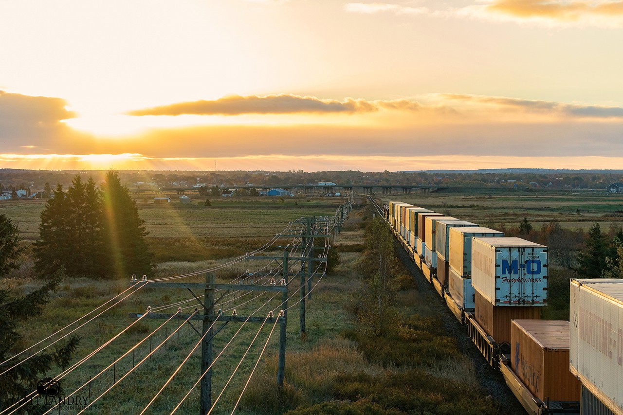 With the sun peeking through, CN 120 heads into the sun, towards the town of Amherst, Nova Scotia. Seen here, at Fort Lawrence, shortly after crossing the New Brunswick/Nova Scotia border, which can be found behind me.