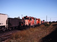 The Cobourg turn creeps along the siding as an eastbound train rolls by on the main. Photo by my brother.