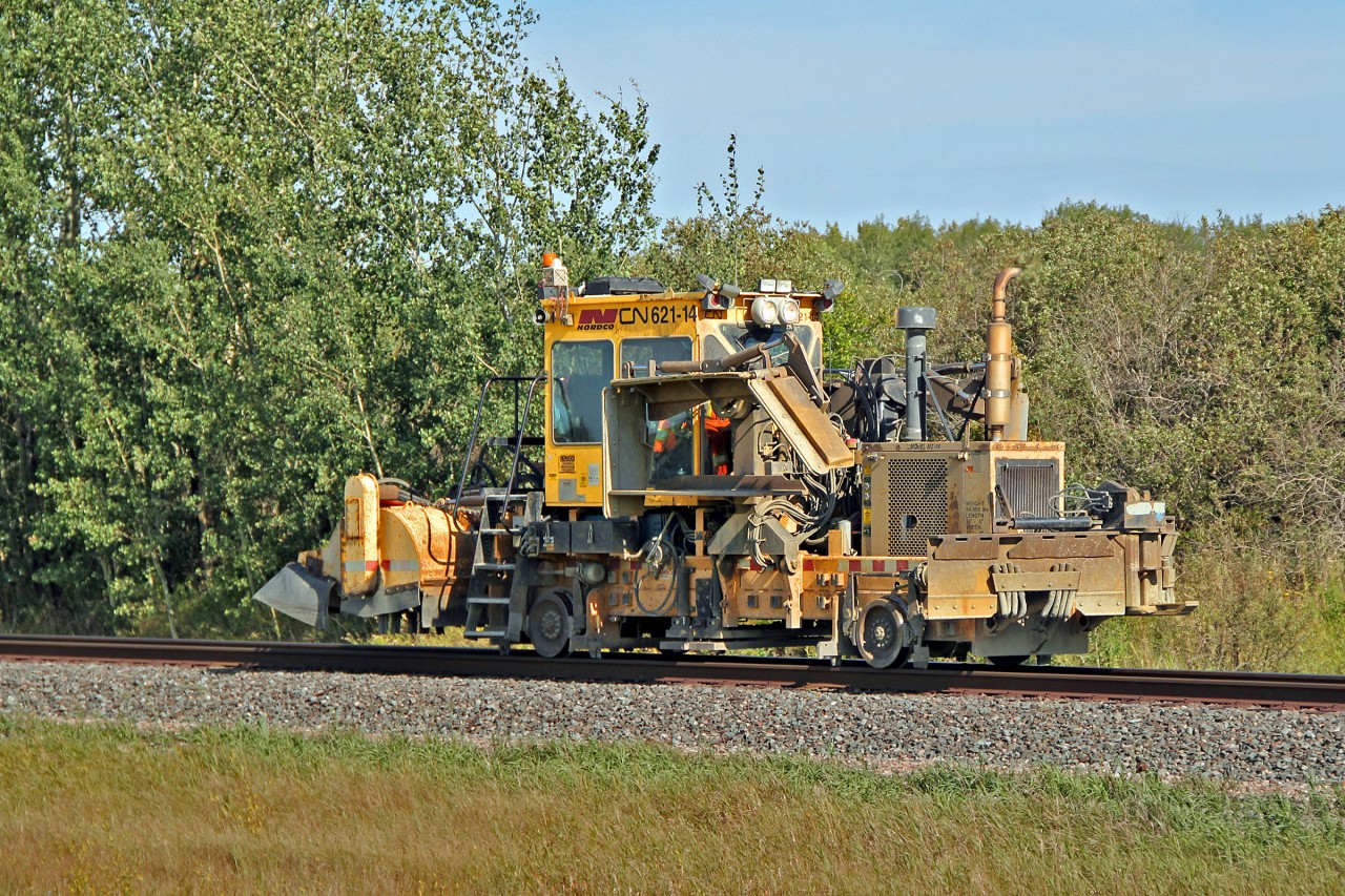Nordco model M42-14 Ballast Regulator/Snow Fighter is seen, minus snow blades, travelling east between Uncas and Lindbrook.