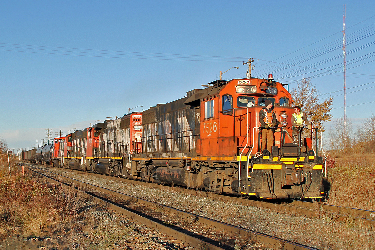 Catching the late afternoon sun it's a very nice Fall day to be riding the front of the locomotive during switching operations. This trio of GP38-2's plus a GMD1 are heading south on the Camrose sub, shortly to stop and switch back across 17th Street into the industrial sidings leading to the Rio Tinto Alcan plant. Four of the loads are petroleum coke waste which is processed at the plant. The lead locomotive is GP38-2 CN 7526, followed by GP38-2(W)'s 4781 and 4778, and at the rear GMD-1u CN 1433.