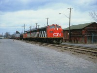 Here is another view from way back when the Nanticoke Steel train ran thru the bowels of Hamilton. This shot is taken a day later than a shot previously posted. Power is CN 9619, 9196 and 9172; and the train is just crossing Barton St and the ratty pavement is old Ferguson Av. Not all that scenic, but this IS downtown Hambone, so beauty was not to be expected. On the extreme left is the Hamilton detention centre, or, as we know it, the Barton Street Jail.