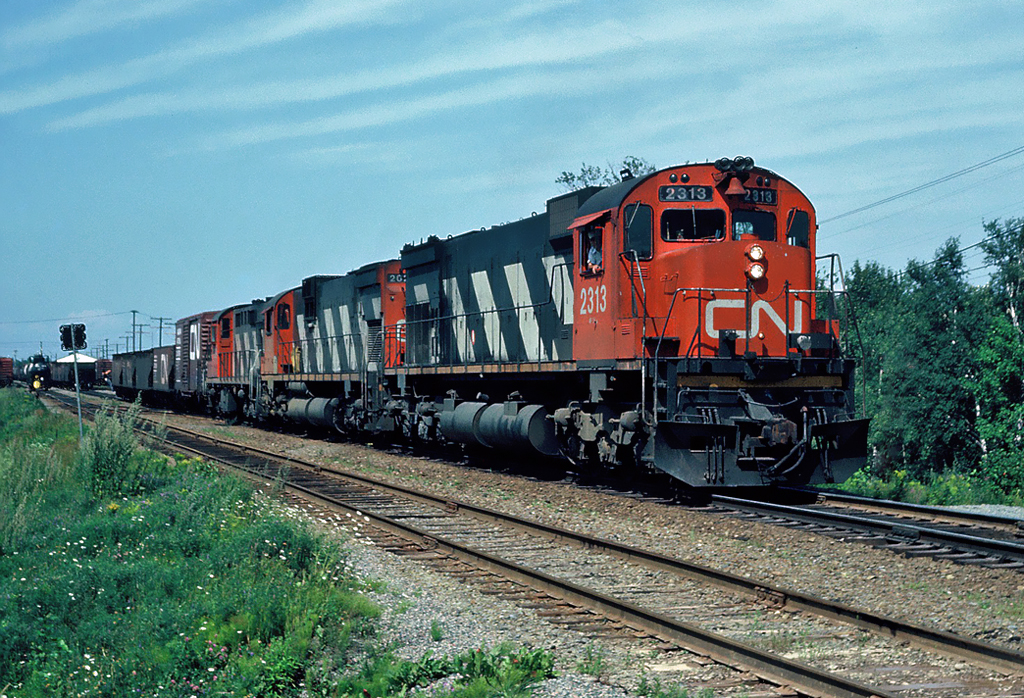 Picking up cars in Bathurst, New Brunswick Canadian National MLW M-636 No.2313, with MLW C-630M No.2014 and MLW RSD No.1768. Sept.19, 1983.