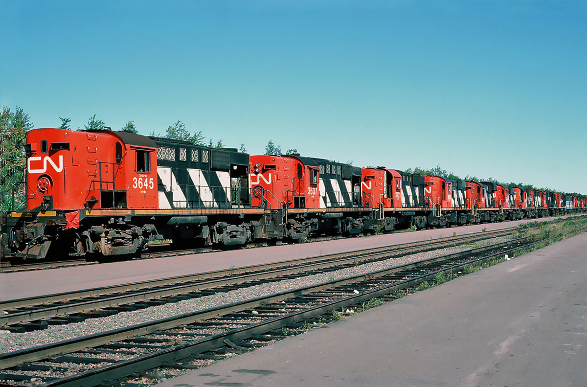 MLW Deadline of RS-18s and even a VIA Rail FPB-4 6863 at CN's Gordon yard, Moncton, New Brunswick September 25, 1988