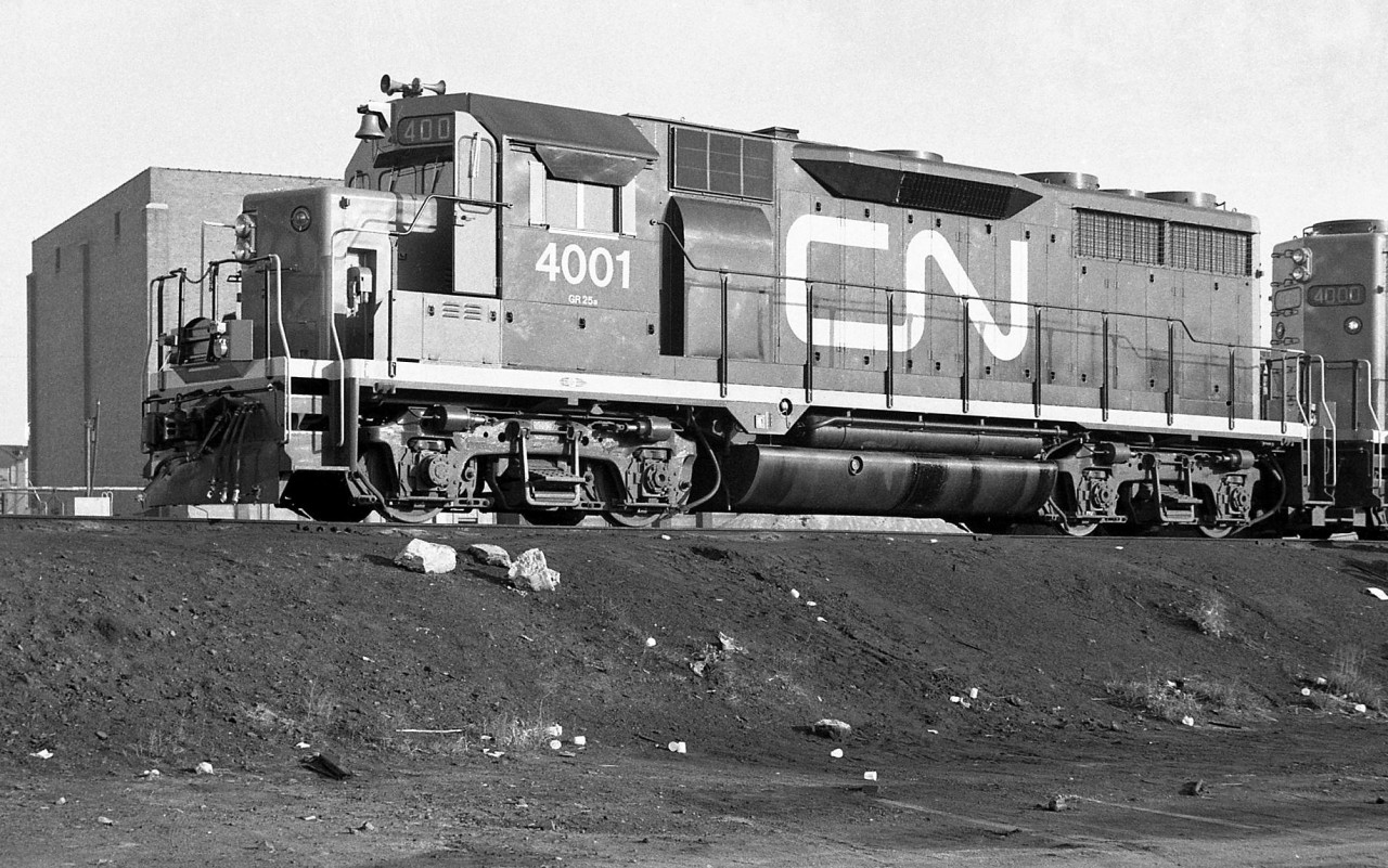 Brand new CN GP35 4001 poses with sister 4000 at Mimico in October 1964, probably after their first trip from GMD London. CN's first foray into higher horsepower second generation diesels were orders in 1964 of the two pictured GP35's from GMD, and two C424's from MLW (3200-3201).

The GP35 model was never that popular with Canadian railways: CP ordered just 24 examples, while CN dabbled in 2 and later came back for 16 of the GP35's successor: the GP40 (followed by over 200 of the Canadian safety cab equipped GP40-2L/W units).

Both of CN's GP35 units were eventually renumbered 9300 and 9301, and lasted in service until being retired in 1984. 4001 (as 9301) was stripped for parts and scrapped at Mandak Metals.