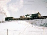 A Canadian National auxiliary train heads north on the Fergus Sub south of Branchton (just north of Highway 5). In consist trailing the steam engine is CN "Hook" 50012, a 200-ton steam powered wrecking crane built by Industrial Brownhoist in 1928. Where this train came from I could not find out - possibly Hamilton (did they base an auxiliary there?) Toronto or London? This is my only photo of a steam powered auxiliary. While they saw infrequent use, most of the large old steam wrecking cranes on CN & CP ended up being converted to diesel power in the years following the end of steam (and some built new as diesel cranes).