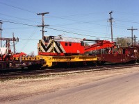 CN's Toronto Auxiliary is seen passing through Paris Junction enroute to assist in cleanup of a wreck further west. Here we see the auxiliary's "Big Hook" in consist: CN 50397, a 1957-built 250-ton Industrial Brownhoist wrecking crane, and the biggest of the big when it came to rail cranes. Note the CN employees riding its boom idler/tool car. At last check, 50397 was still on the roster but noted as being for sale.
<br><br>
The wreck the Toronto Auxiliary was heading to was the same wreck that the London Auxiliary was also heading to, pictured passing through Woodstock here: <a href=http://www.railpictures.ca/?attachment_id=25965><b>http://www.railpictures.ca/?attachment_id=25965</b></a>