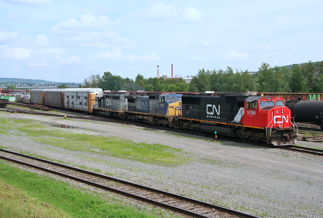 Canadian National EMD SD75I 5786 with CSX C40-8W 7663 and CN(GTW) SD40-3 5955 westbound at Edmundston,New Brunswick  July 12, 2006.