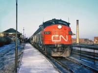  Westbound at Canadian Pacific's Westmount Station in December 1964 is the late afternoon pool train with their mix of CN and CP cars, The International Limited bound for Toronto. In charge today is CN's FP9 6502 and F9B 6610.
