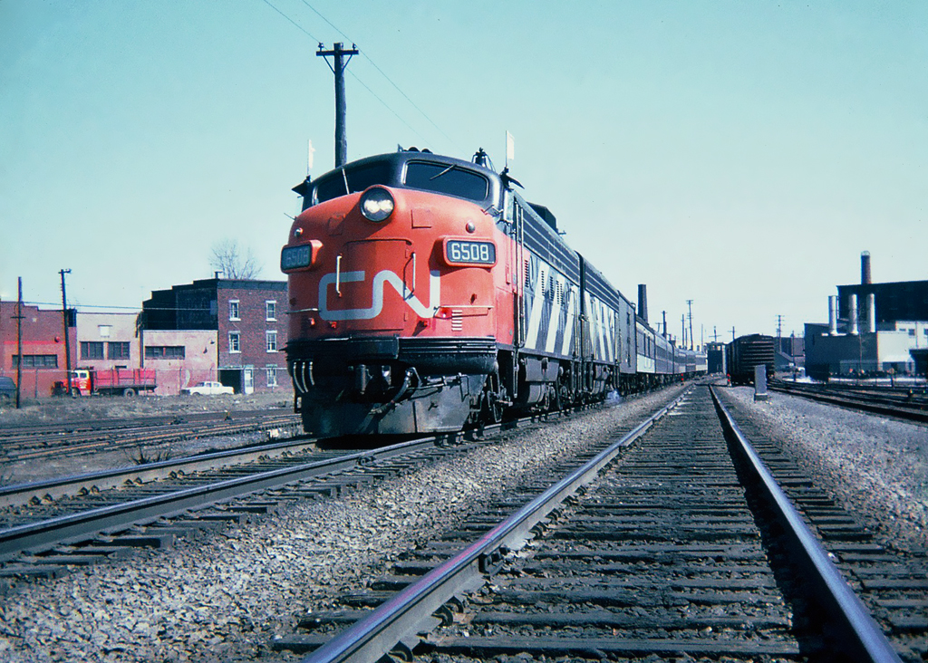 One of many CN Montréal-Toronto daily passenger trains, leading this westbound train GMD FP9(A)6508. Montréal, Québec April 21, 1965.