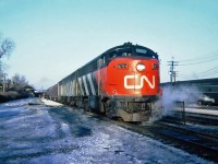    Late afternoon CN-CP pool train The International Limited, bound for Toronto at Canadian Pacific Westmount Station. In charge is CN's CLC (FM) passenger C-Liner CPA16-5 No.6705 with GMD FPB NO.6601 and MLW FPA-4 No.6783 March 19, 1965.
