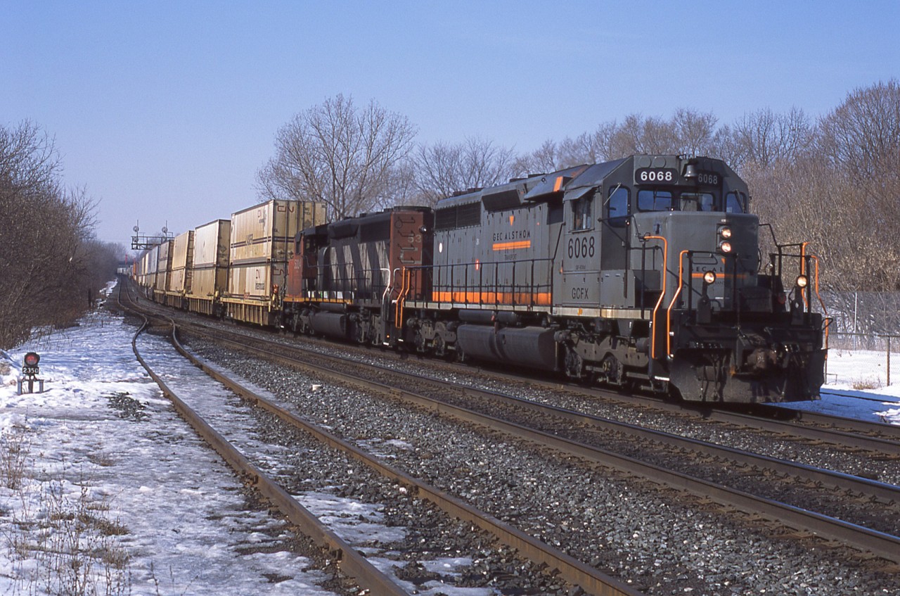 CN# 142 makes it's way east through Georgetown Ontario with a grungy looking pair of SD40 variations on the point.