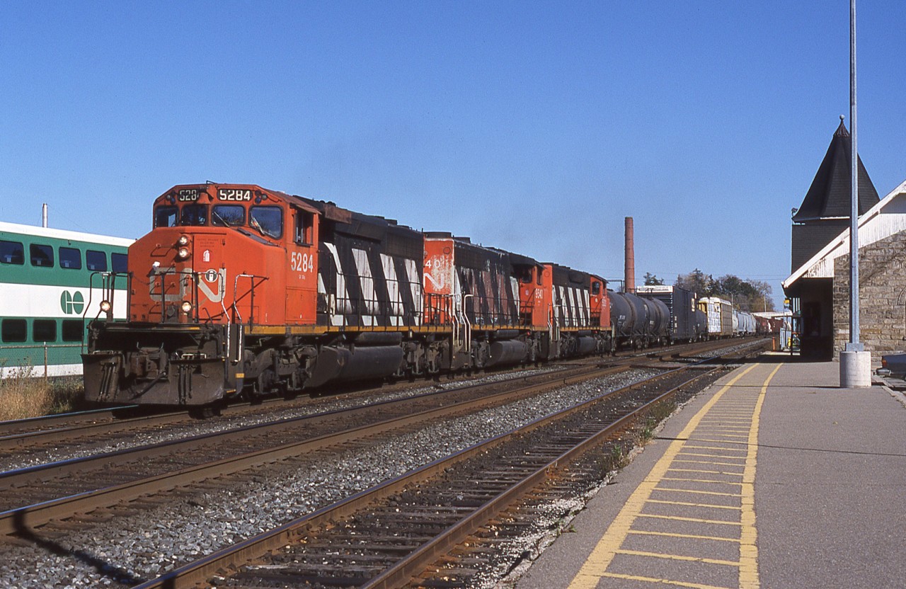 October 14th 2000 finds a trio of CN GMD's all still decked out in zebra colours passing through Georgetown station.