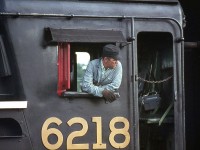 CN Northern 6218's fireman leans out of the cab window of his steed, keeping a watchful eye on the goings-on during a steam fantrip stop at Harrisburg, in September 1970.