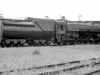 Canadian National 4-8-4 Northern 6301 (U3a class, built by Alco in Schenectady for GTR but transferred to CN) is seen here at Mimico Roundhouse in 1956. It's main driving rod appears to be removed, suggesting it may be undergoing maintenance or being set up for transport to a heavier shop such as Stratford. It wouldn't be scrapped until 1960 and appeared to still be in pretty good shape, so wasn't facing retirement just yet.<br><br>Another view of 6301 at Clarkson Station a year later: <a href=http://www.railpictures.ca/?attachment_id=13305><b>http://www.railpictures.ca/?attachment_id=13305</b></a><br>Lots of big steam on the ready tracks at Mimico: <a href=http://www.railpictures.ca/?attachment_id=15340><b>http://www.railpictures.ca/?attachment_id=15340</b></a><br>Ontario Northland power at Mimico Roundhouse: <a href=http://www.railpictures.ca/?attachment_id=15146><b>http://www.railpictures.ca/?attachment_id=15146</b></a>
