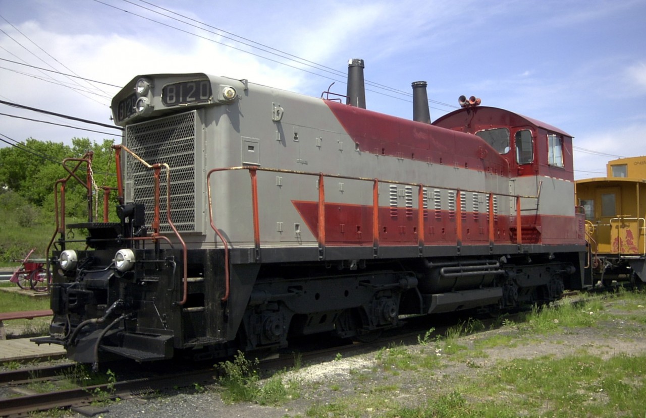 Just before the summer begins in 2002, CP 8120 (DRs 12a) is getting a fresh coat of maroon & grey paint at the Lake of the Woods Railroad Museum in Keewatin, ON.  The van in the background could also use a freshening up.