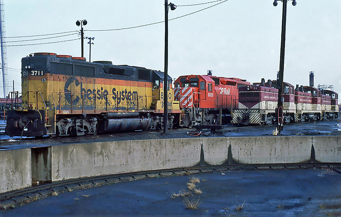Chessie System (B&O) EMD GP40 No.3711 with a CP Rail GMD SD40 No.5525 and three stored Toronto, Hamilton & Buffalo switchers, two EMD NW2s numbers 54 & 53 and a GMD SW9 No.56  October 23, 1987.