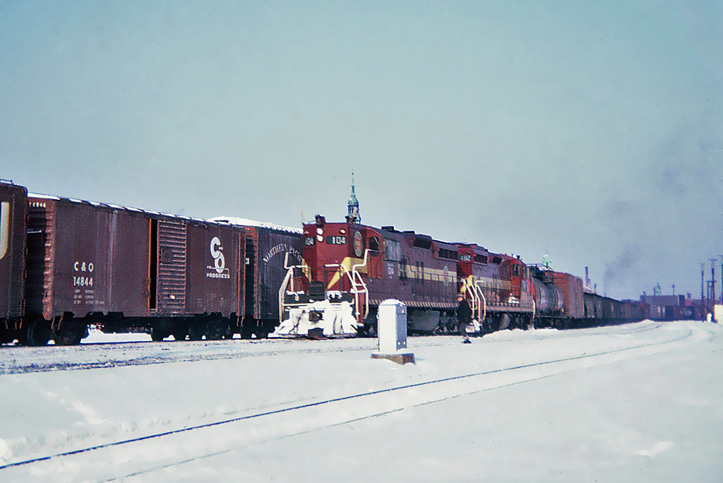 Two Duluth, Missabe and Iron Range SD9's exemplify some of the diverse, leased power that worked both the CN and CP during the mid-60"s.Number 104 and sister 152 work west with an extra at Montreal in February 1965.