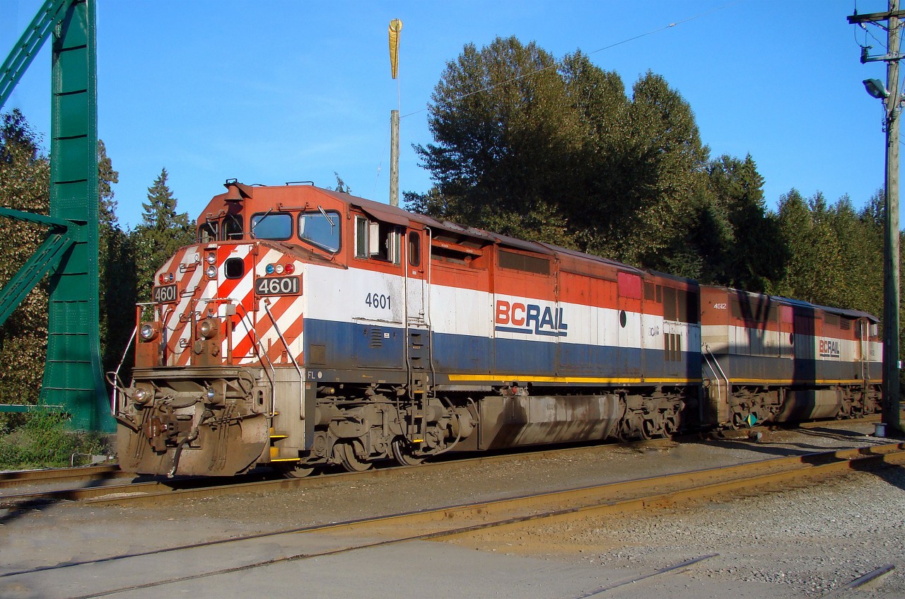 In the CN era but you could still pretend it is BC Rail, Dash 8-40CMu (upgraded to 4400 hp and Dash 9 specs) 4601 and 4612, bathed in the evening sunshine, are switching at the west end of the North Vancouver yard, right under Lion's gate Bridge.