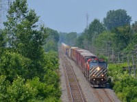 <b>Double ditchlights on the north track.</b> CN 372 has a BC Rail leader and another mid-train (BCOL 4646, CN 2600, CN 2406 & BCOL 4651 DPU) as it passes through Pointe-Claire, past MP 13 of the Kingston sub. 
