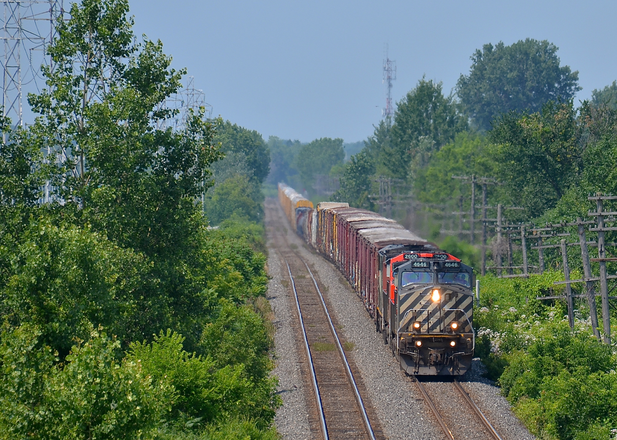 Double ditchlights on the north track. CN 372 has a BC Rail leader and another mid-train (BCOL 4646, CN 2600, CN 2406 & BCOL 4651 DPU) as it passes through Pointe-Claire, past MP 13 of the Kingston sub.